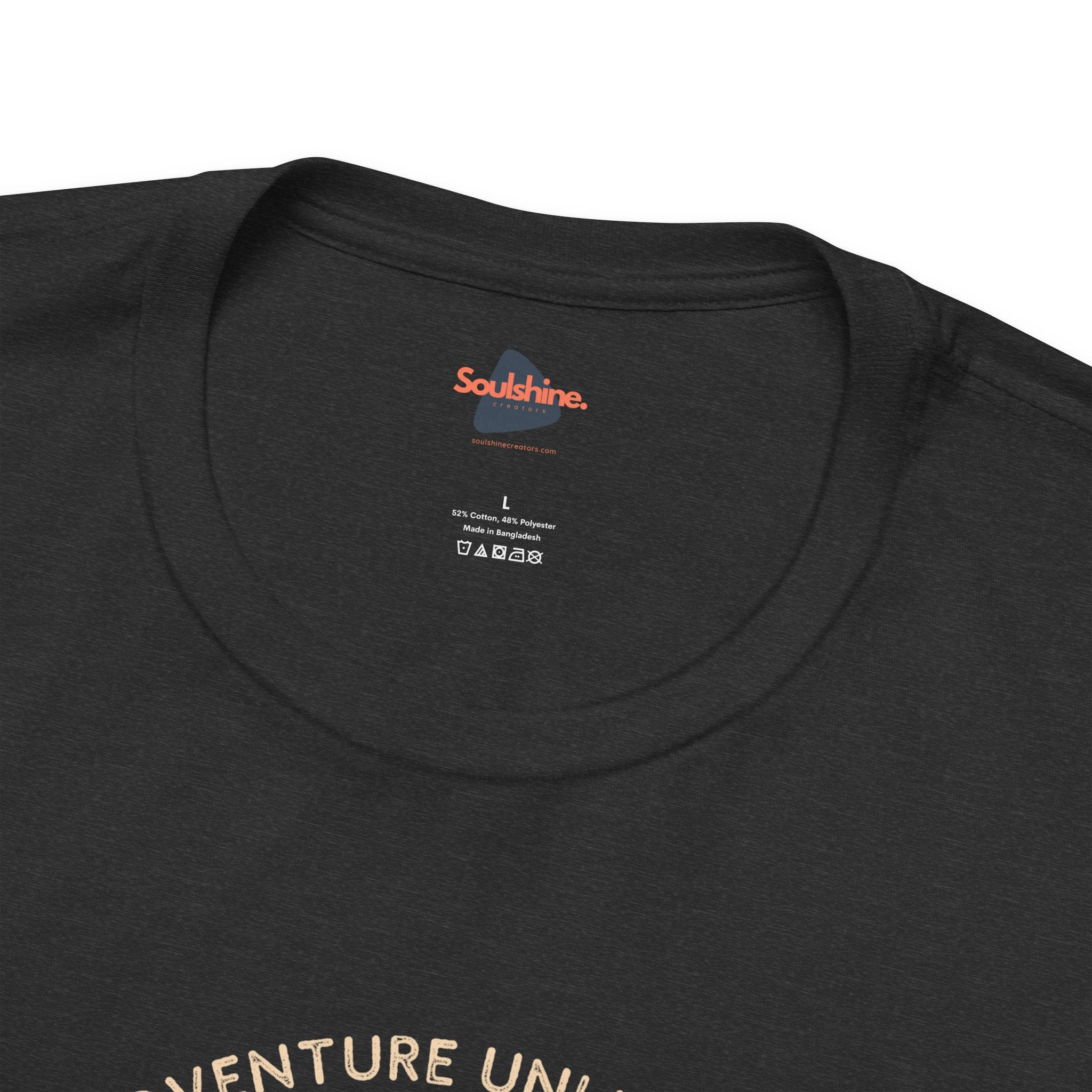 Adventure Unlimited unisex black t-shirt with ’adventure’ printed on it